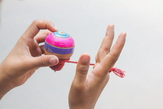 Classic wooden spinning top toy with string