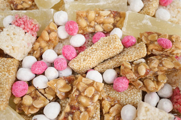 Chinese snacks. Colorful food background. with selective focus on the pink peanuts.