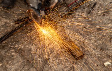 Naklejka na ściany i meble Sparks from sawing metal at a construction site