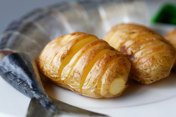 Baked golden potatoes with herring mackerel