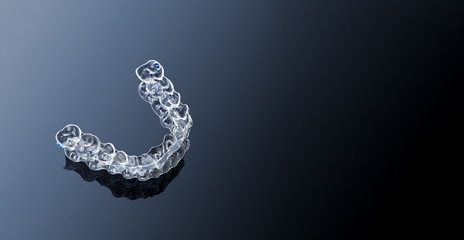 Invisible orthodontics cosmetic brackets on gradient background, tooth aligners, plastic braces....