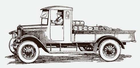 Man driving antique delivery truck with cargo in side view, after engraving from early 20th century