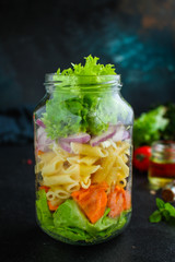 healthy salad in a jar (vegetable snack pasta salad) menu concept. food background. top view. copy space