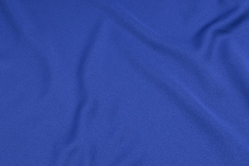 Fototapeta na wymiar Sport Clothing Fabric Texture Background. Top View of Cloth Textile Surface. Blue Football Shirt With Copyspace.