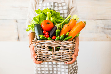 Caucasian woman people with bucket full of coloured and mixed fresh healthy food like fruit and...