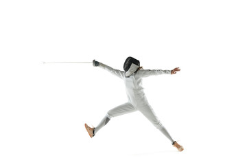 Teen girl in fencing costume with sword in hand isolated on white studio background. Young female...