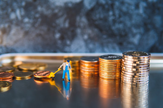 Miniature people, man pulling stack coins using for logistic, business and financial concept - Powered by Adobe
