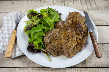 grilled prime rib and salad on a plate