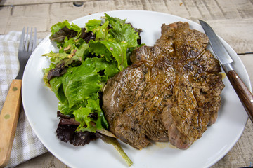 grilled prime rib and salad on a plate