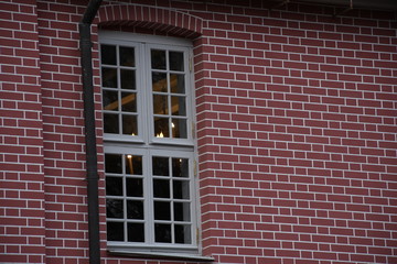 white window on a brick wall. 