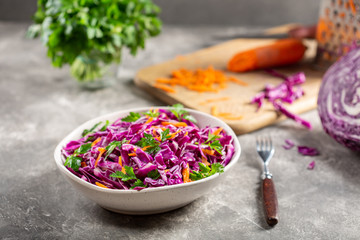 Red cabbage salad with carrots in a bowl.