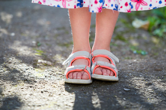 Close Up Of Child Girl Feet Wearing Summer Sandals Shoes