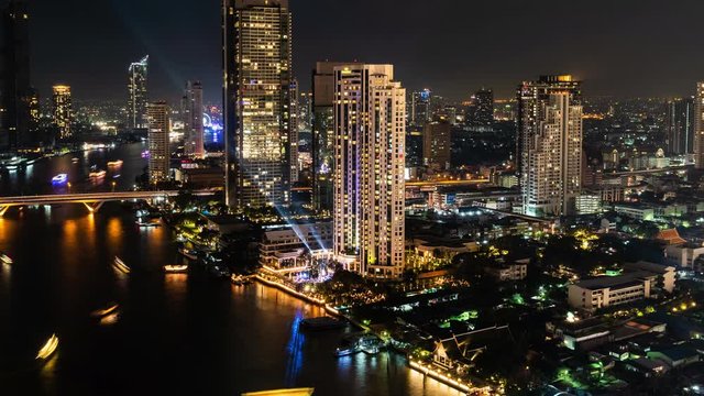 An aerial view of  Bangkok cityscape including Chao Phraya River during night time, Time lapse 4K