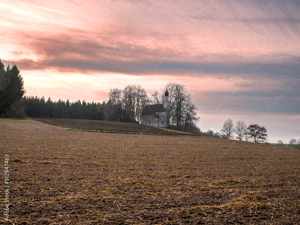 Wall mural Church at Herrnrast Ilmmünster Bavaria with pink sky sunset