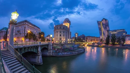 Fotobehang Urania and Danube Canal day to night timelapse in Vienna. © neiezhmakov