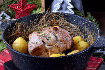 Hay roasted pork tenderloin and potato. Festive meal on the table