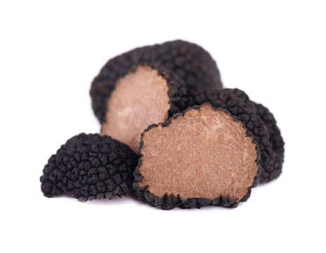 Black truffles isolated on a white background. Fresh sliced truffle. Delicacy exclusive truffle mushroom. Piquant and fragrant French delicacy. Clipping path.