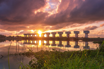 Sunrise and canal with Uthokvibhajaprasidbarrage in Pak Phanang. Thailand