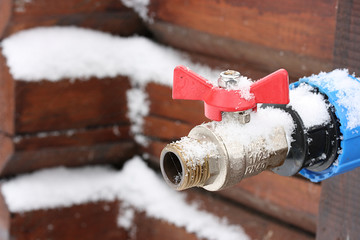 Crane with red handle on brown wood background