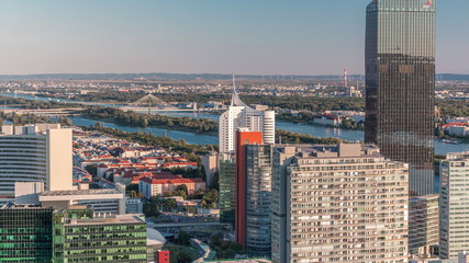 Aerial panoramic view of Vienna city with skyscrapers, historic buildings and a riverside promenade timelapse in Austria.