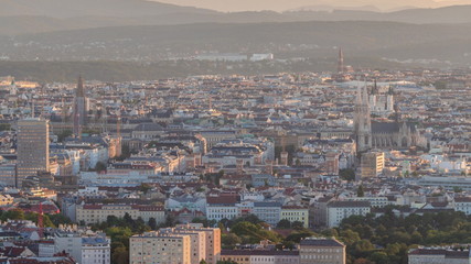 Aerial panoramic view of Vienna city with skyscrapers, historic buildings and a riverside promenade timelapse in Austria.