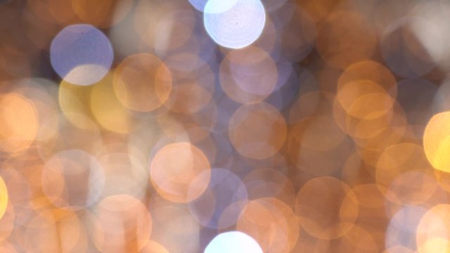 Festive golden elegant abstract video bokeh background of defocused holiday led lights. Real time 4k video footage.