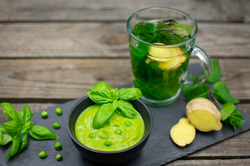 Pea cream with basil on black slate.