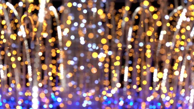 Festive golden elegant abstract video bokeh background of defocused holiday led lights. Real time 4k video footage.