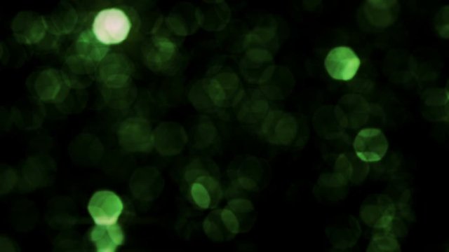 Defocused hexagons particles falling over black background. Green. Set of 3 videos: vertical wipe, horizontal wipe and loopable background. More options in my portfolio.
