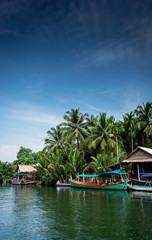 Fototapeta na wymiar traditional jungle boat at pier on tatai river in cambodia