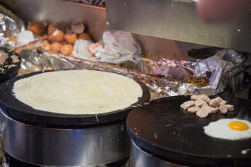 French chef cooking traditional galette in Rennes ,France.