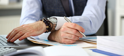 Fototapeta premium Clerk man at office workplace with silver pen