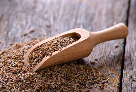 Cumin seeds on wooden table