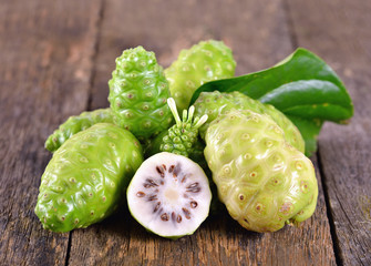 Noni fruit on wooden table