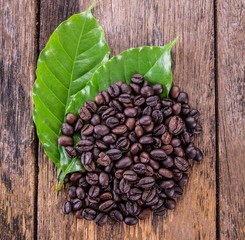Coffee seed and leaves on table
