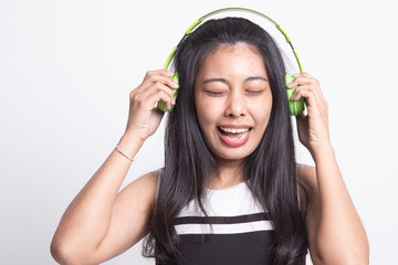 Too loud.  portrait of  young asian woman  holding  headphones and making unhappy face.