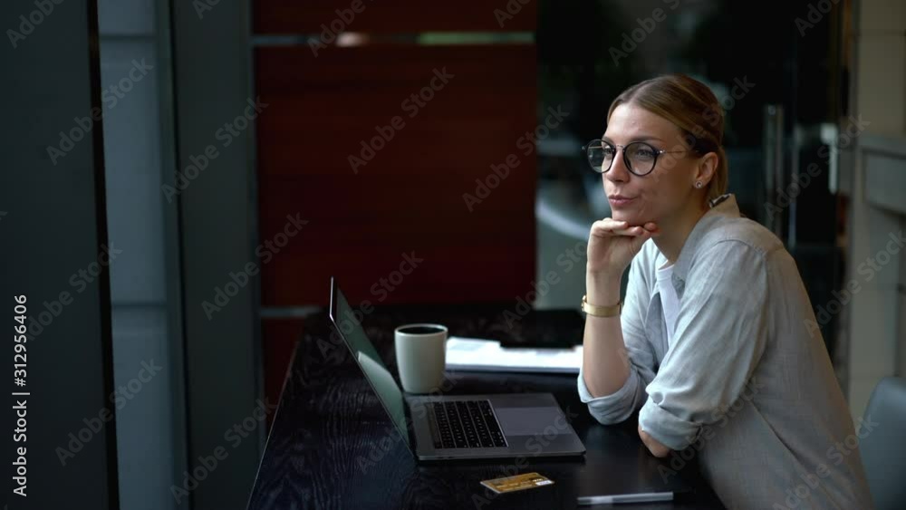 Poster pensive woman thinking on idea while working remotely on digital netbook connected to wireless inter