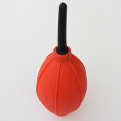 Fototapeta premium Red and black camera air blower for clearing dust particles from lens.