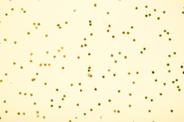 Golden stars composition on colored background. Flat lay.