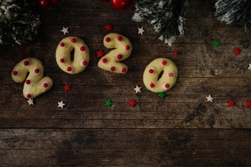 2020 shaped  new year sugar cookies on rustic wooden background