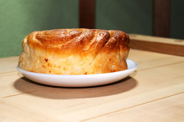 The soft bread is arranged or isolated on a white plate on a smooth wooden board background with blank text areas from side