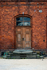 Detail of the historical building - former train station. Authentic masonry brickwall, doors and other architectural details.