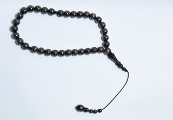 Handmade rosary necklace made of beads, black agate and silver on white Background	