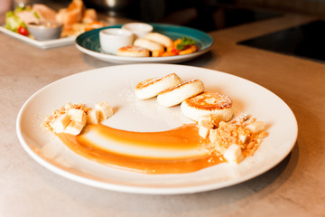 Dish cheese pancakes with caramel sauce and bananas