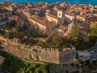 Fototapeta na wymiar Aerial view of the cathedral, Cathedral of Maria Santissima of Romania. Roofs and houses of the city of Tropea, Calabria. Italy. 