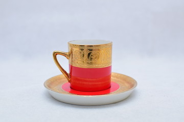 Mock up / design set of elegant and traditional colorful Red and gold traditional elegant coffee cup & Tea cup on cup's plate , template for branding identity and company logo design/ drink-ware