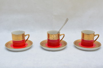 Mock up / design set of elegant and traditional colorful Red and gold traditional elegant coffee cup & Tea cup on cup's plate , template for branding identity and company logo design/ drink-ware