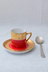 Mock up / design set of elegant and traditional colorful Red and gold traditional elegant coffee cup & Tea cup on cup's plate , template for branding identity and company logo design/ drink-ware