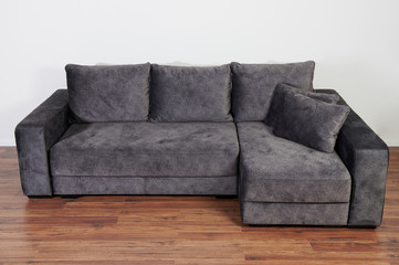 Gray sofa on wooden floor