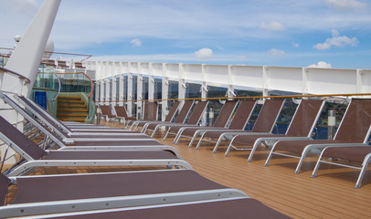 Modern and elegant metal sun beds or sun loungers or deck chairs on luxury Italian MSC Cruises...